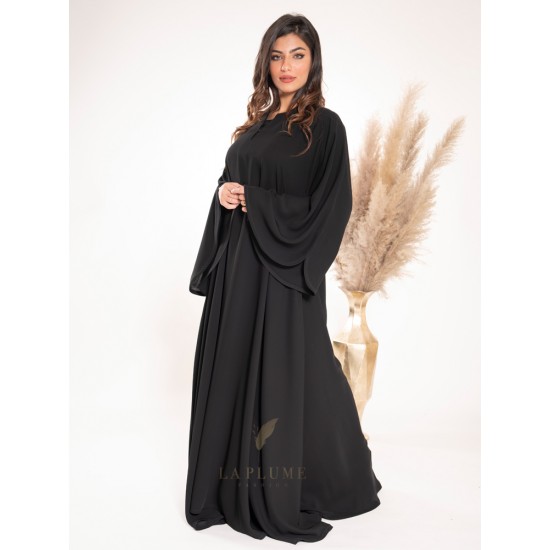 AS1012 Klush closed abaya with a plain black crepe fabric, round neck collar and wide sleeves with curve on the sides