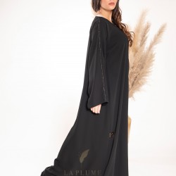 AK3022 Royal black crepe abaya with a calm and sophisticated design, with two lines x on the sleeves and line x from top to bottom from behind the center of the abaya